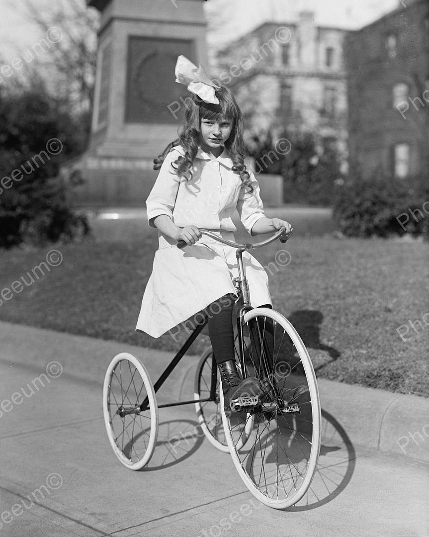 girl riding tricycle